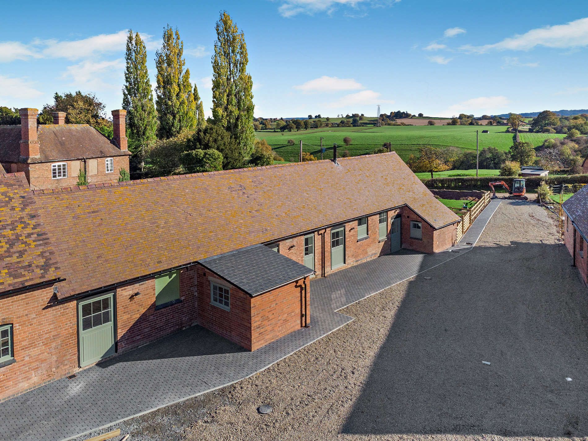 Aerial view of converted barns and farmland