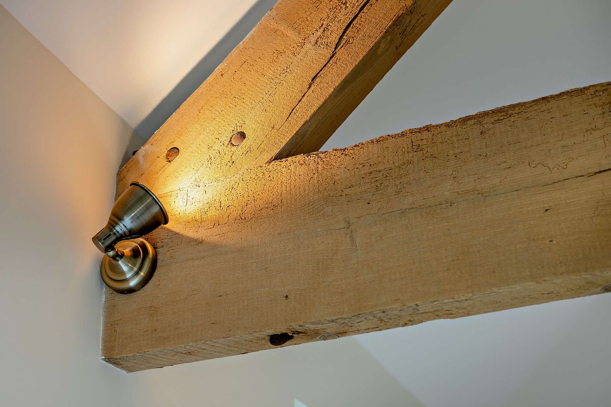 Brass spotlight on an oak beam