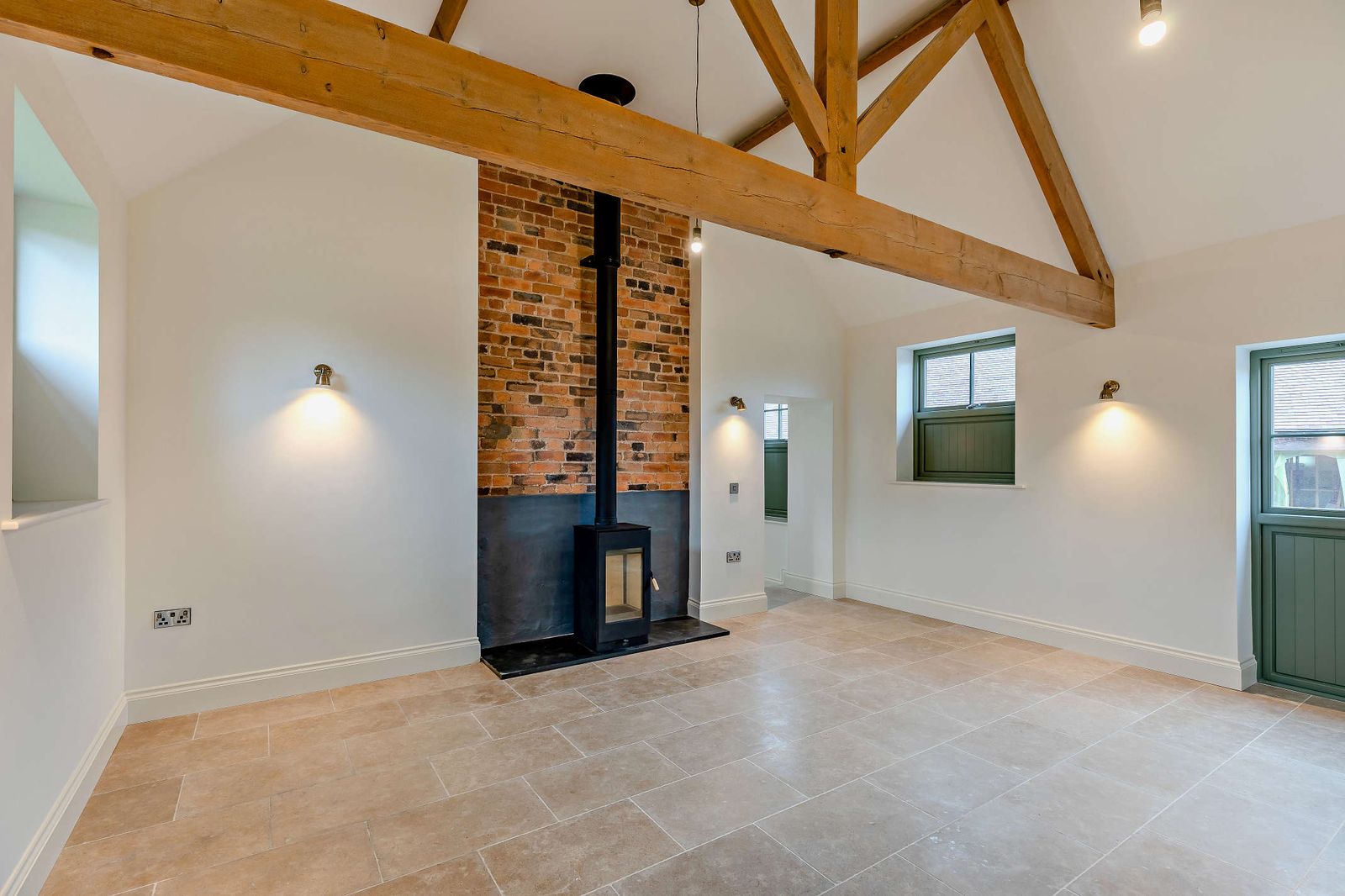 Wood burner set into a brick fireplace