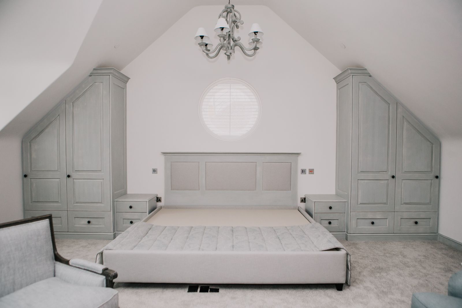 Bedroom with panelled eaves cupboards